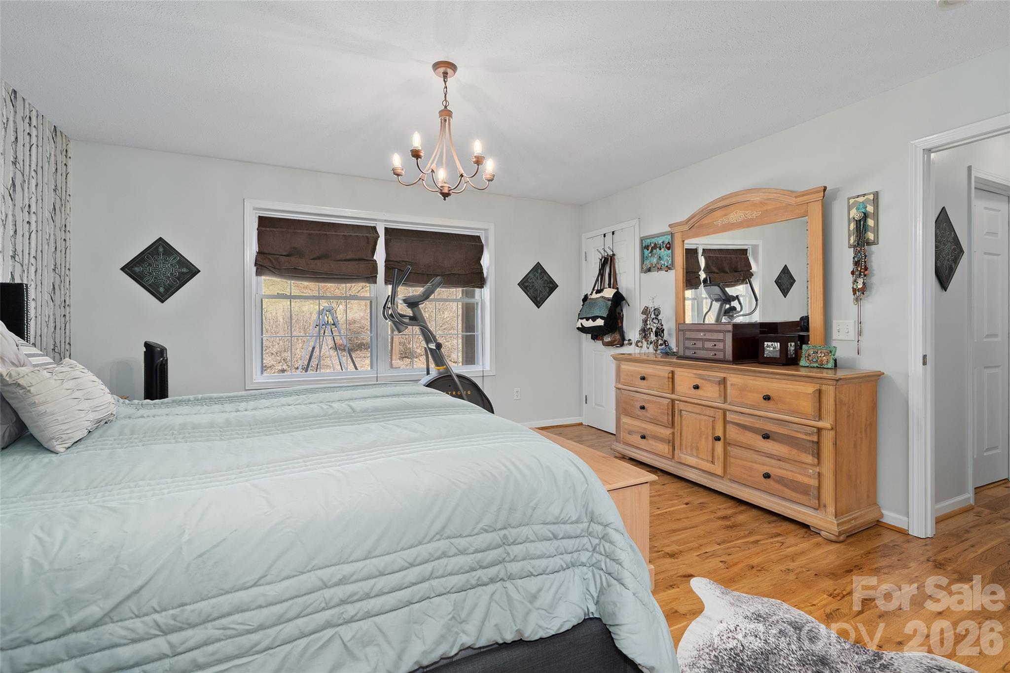 371 Ned Cove Road Waynesville, NC 28785 - Photo 23 of 44 a bedroom with a bed and a dresser