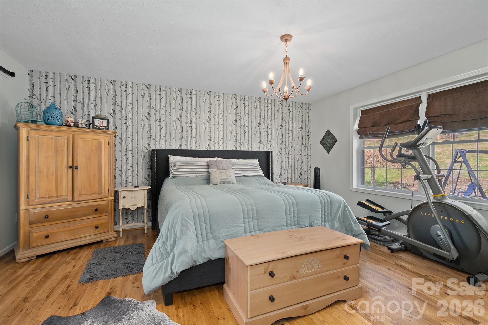 371 Ned Cove Road Waynesville, NC 28785 - Photo 24 of 44 a bedroom with a bed and a dresser