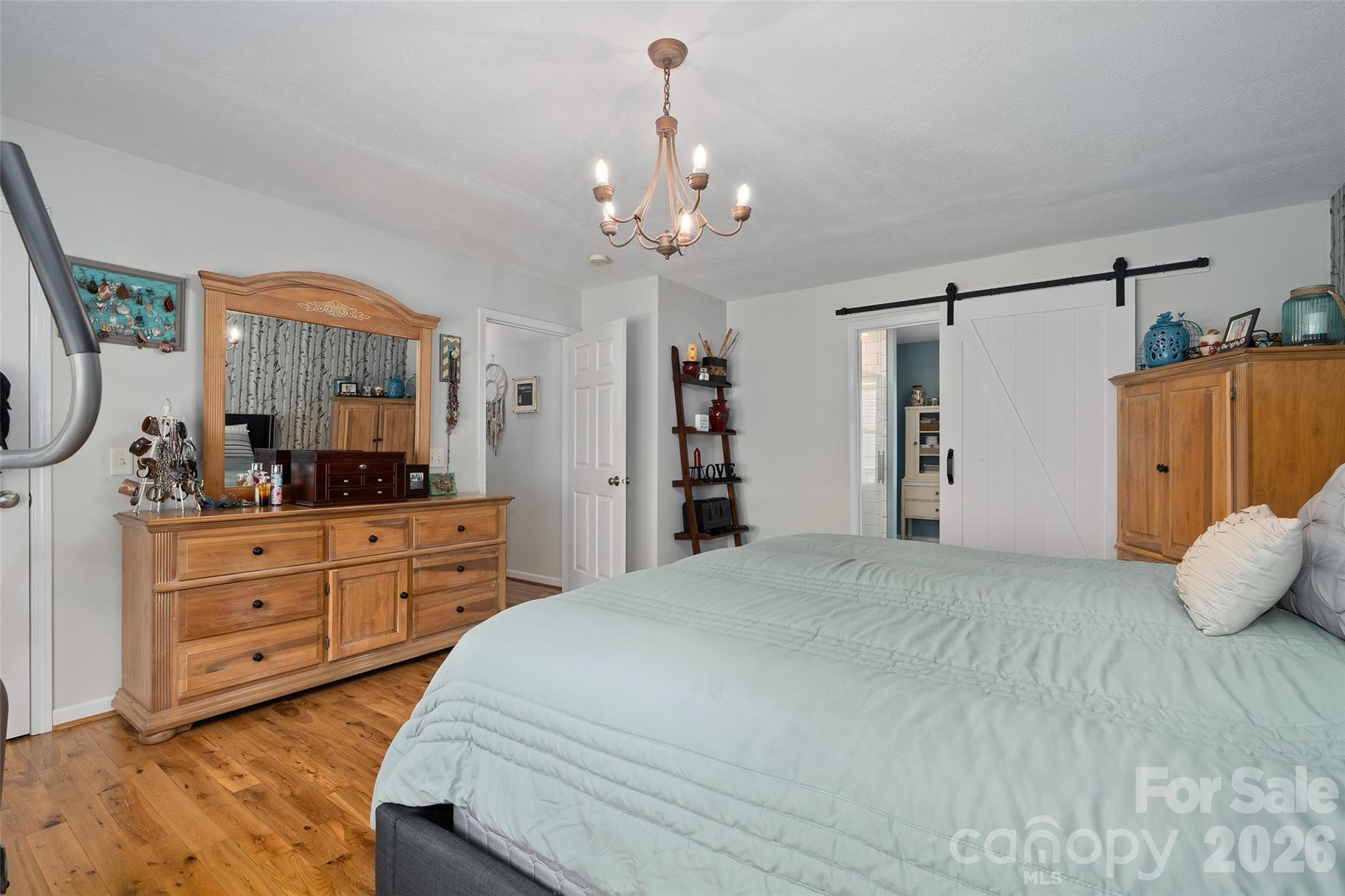 371 Ned Cove Road Waynesville, NC 28785 - Photo 25 of 44 a bedroom with a large bed and a dresser
