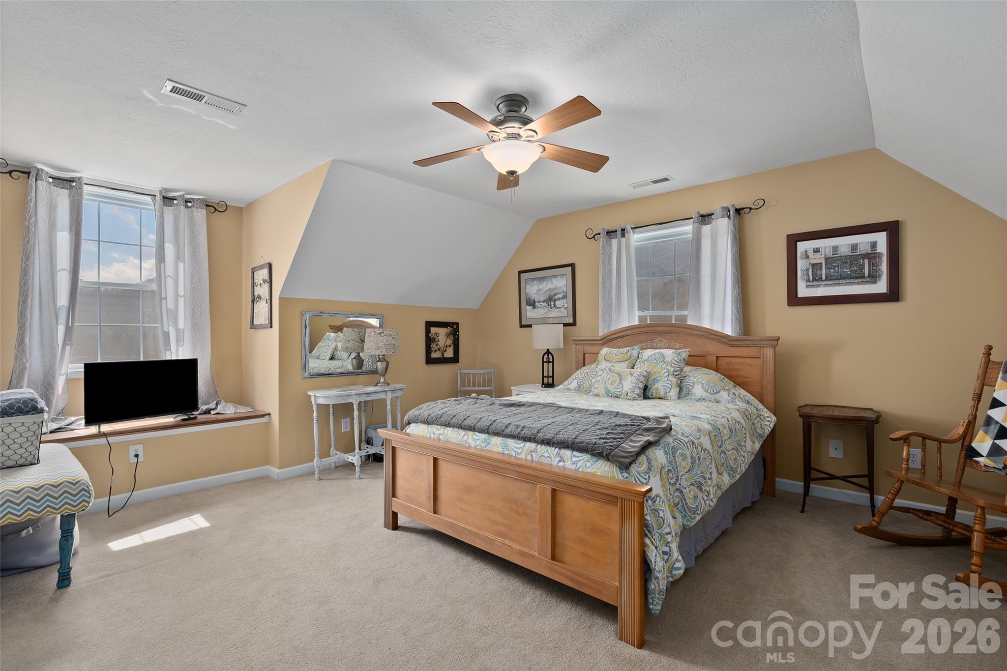 371 Ned Cove Road Waynesville, NC 28785 - Photo 31 of 44 a spacious bedroom with a bed and a flat screen tv