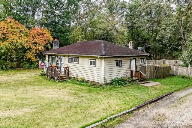 a backyard of a house with yard and barbeque oven