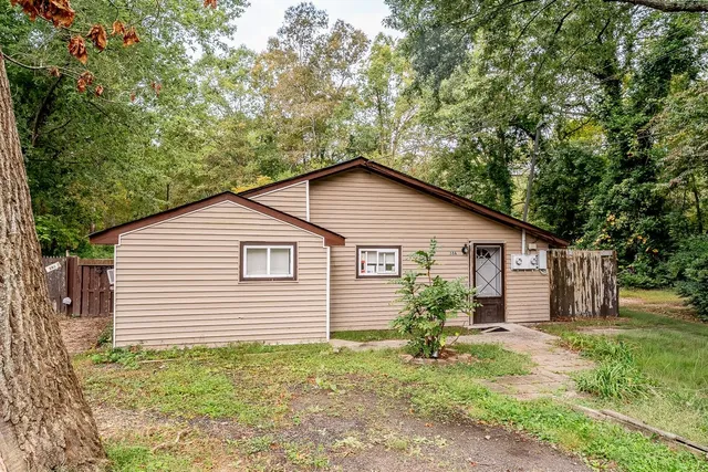 a view of a house with yard and a garden