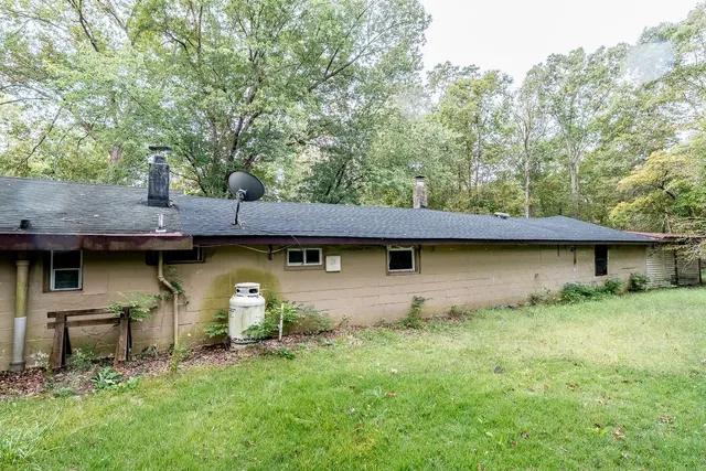 a backyard of a house with table and chairs