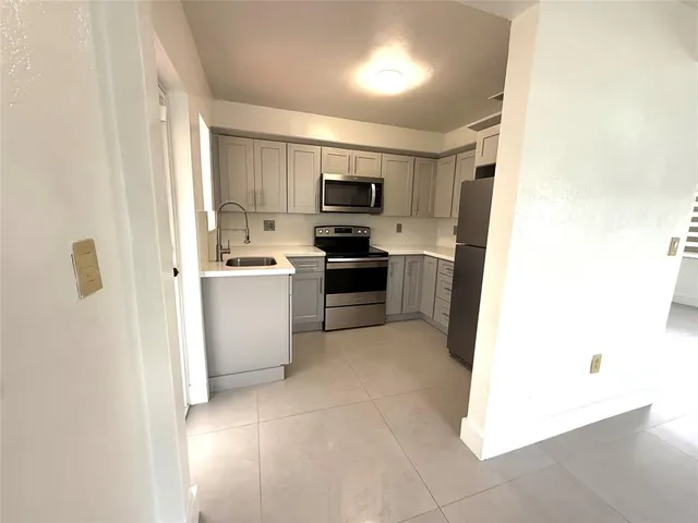 a kitchen with cabinets and stainless steel appliances