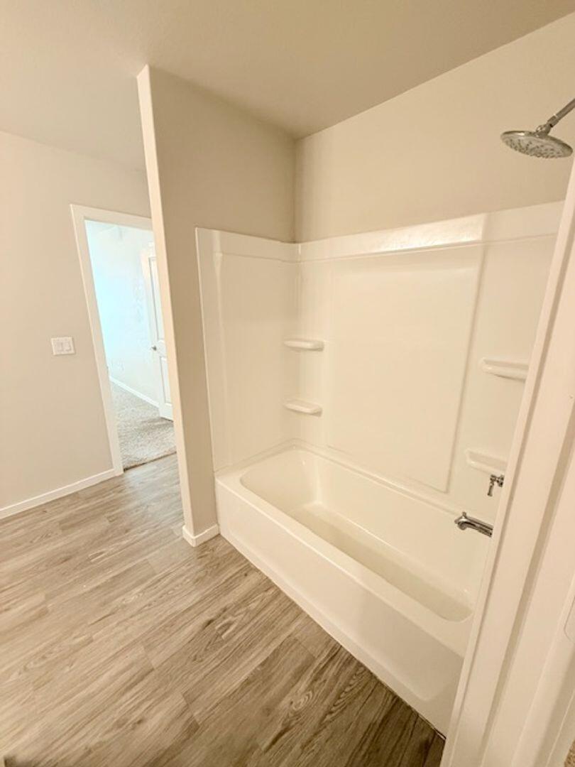2611 136th Street Lubbock, TX 79423 - Photo 11 of 13 a bathroom with a bathtub and a shower