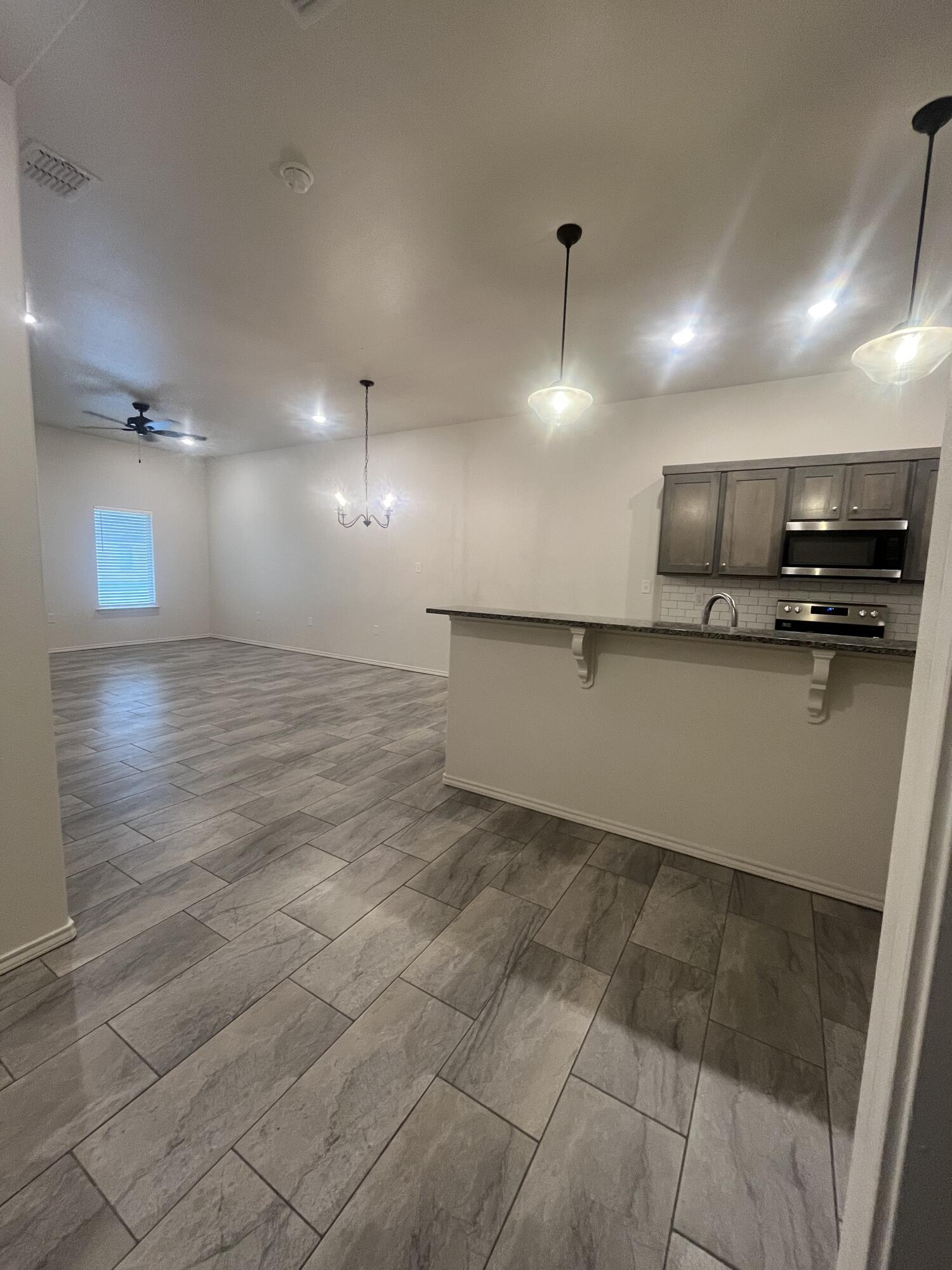 2611 136th Street Lubbock, TX 79423 - Photo 3 of 13 a large kitchen with stainless steel appliances a large counter top
