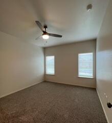 2611 136th Street Lubbock, TX 79423 - Photo 8 of 13 an empty room with a window and a fan
