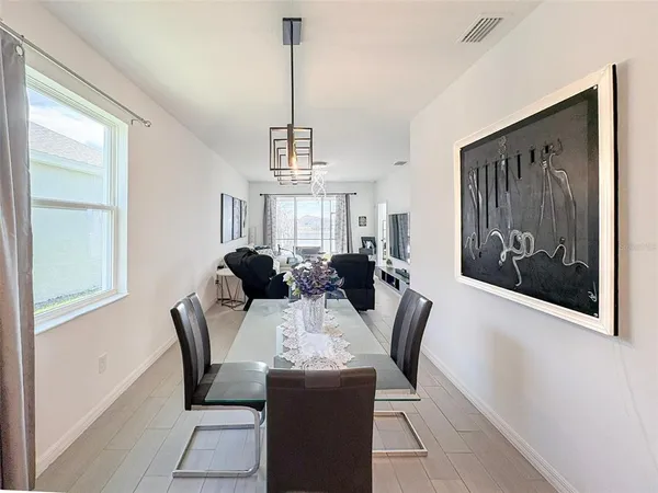 a view of a dining room with furniture and chandelier