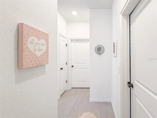 a view of a hallway with paintings on the wall