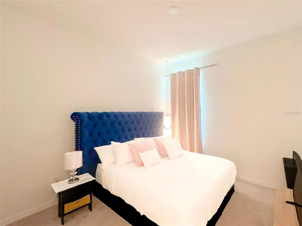 a bedroom with a bed and a tv