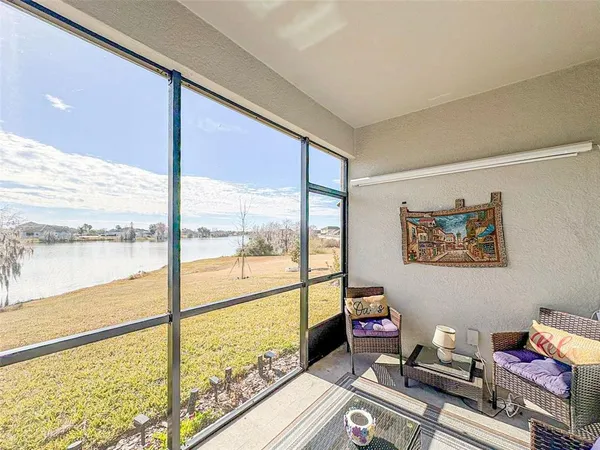 a room with furniture and a floor to ceiling window