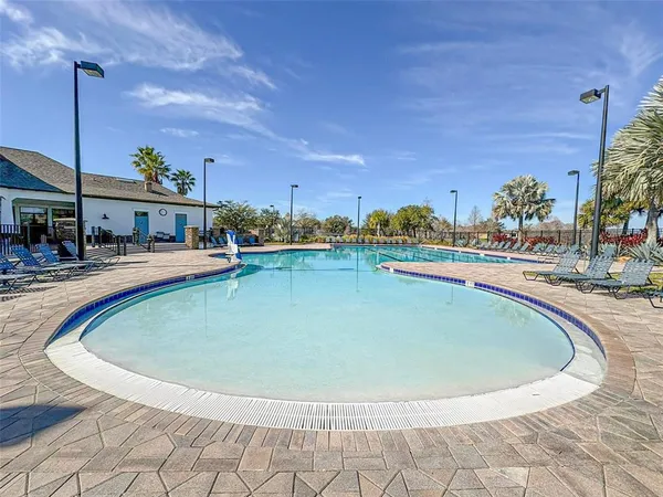a view of a swimming pool with outdoor seating