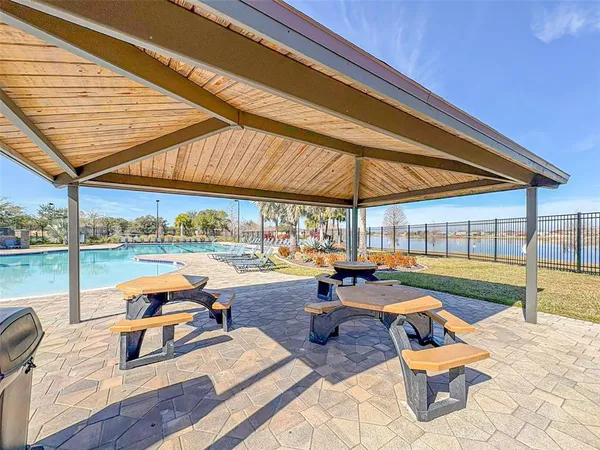 a outdoor space with patio the couches and pool table and chairs under an umbrella