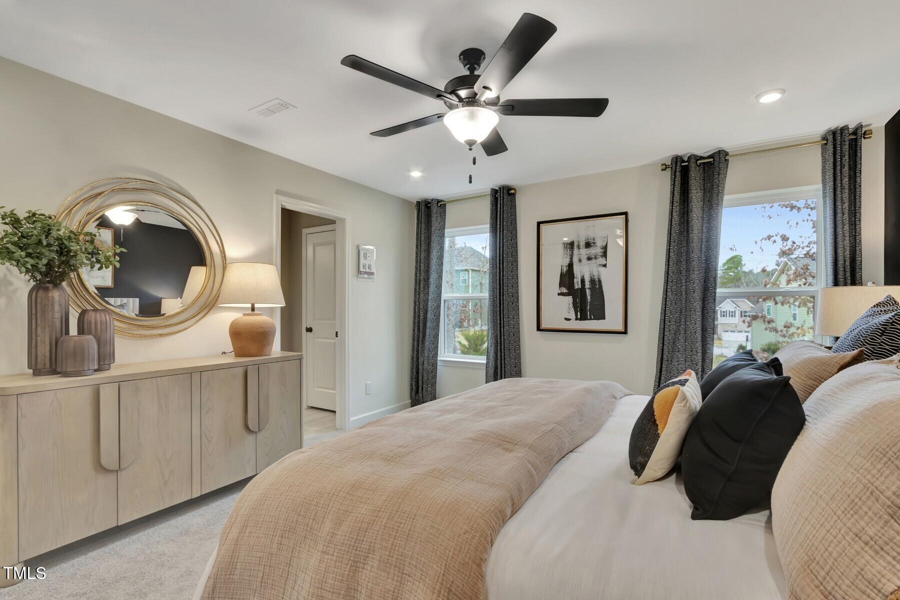 6972 Doddridge Lane Cary, NC 27519 - Photo 13 of 34 a bedroom with a large bed and a chandelier