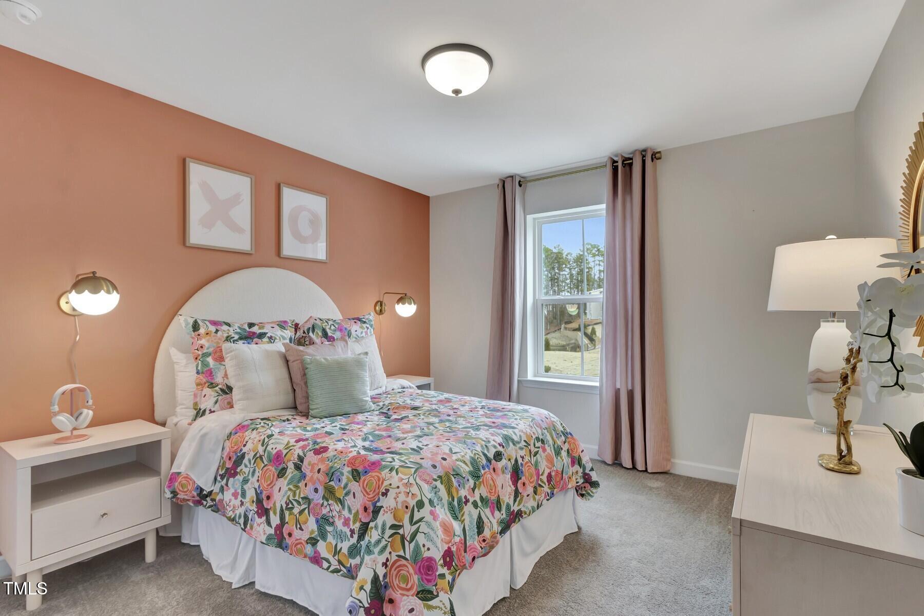 6972 Doddridge Lane Cary, NC 27519 - Photo 20 of 34 a bedroom with a large bed and a chandelier