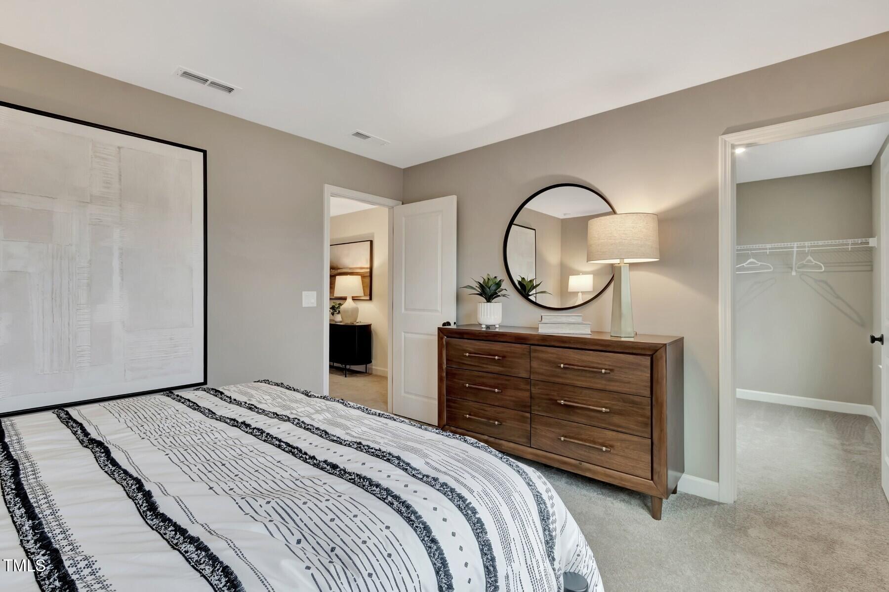 6972 Doddridge Lane Cary, NC 27519 - Photo 21 of 34 a bedroom with a bed and a dresser