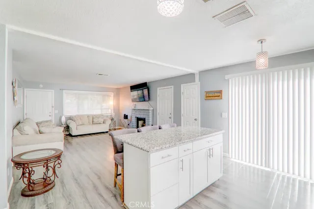 a view of living room with granite countertop furniture and a wooden floor