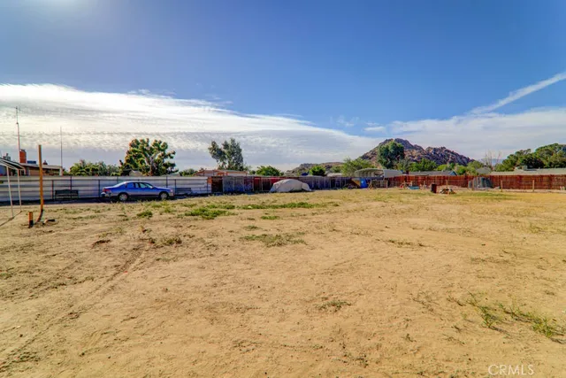 a view of swimming pool with outdoor seating and yard in the back