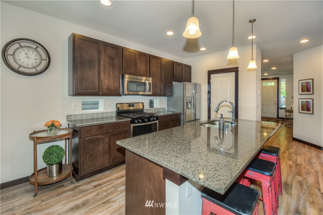 17503 3rd Avenue Southeast Bothell, WA 98012 - Photo 4 of 22 a kitchen with stainless steel appliances granite countertop a sink a stove and refrigerator