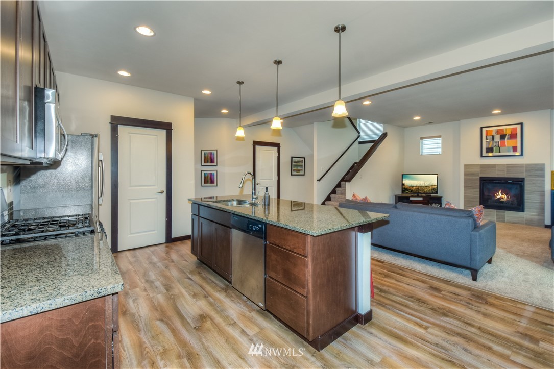 17503 3rd Avenue Southeast Bothell, WA 98012 - Photo 5 of 22 a kitchen with stainless steel appliances granite countertop a sink a stove and a wooden floors