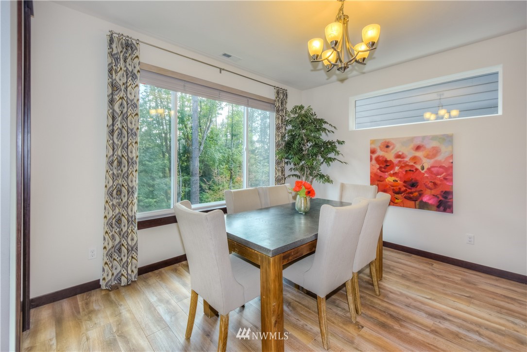 17503 3rd Avenue Southeast Bothell, WA 98012 - Photo 7 of 22 a view of a dining room with furniture wooden floor and chandelier