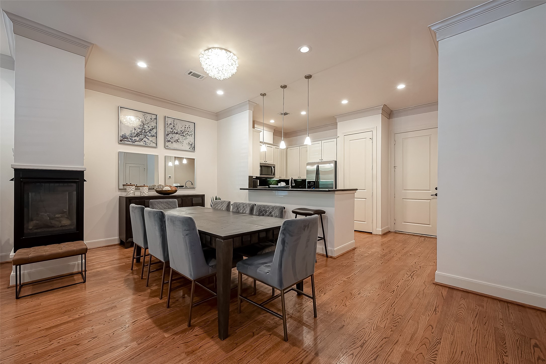56 Riva Row The Woodlands, TX 77380 - Photo 11 of 36 a view of a dining room with furniture window and wooden floor