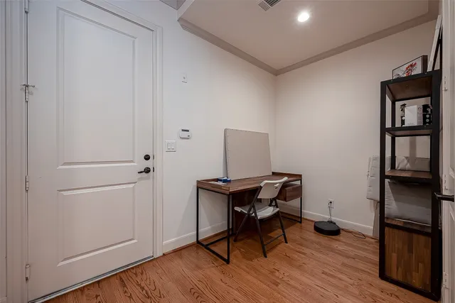 a view of a workspace with furniture and wooden floor