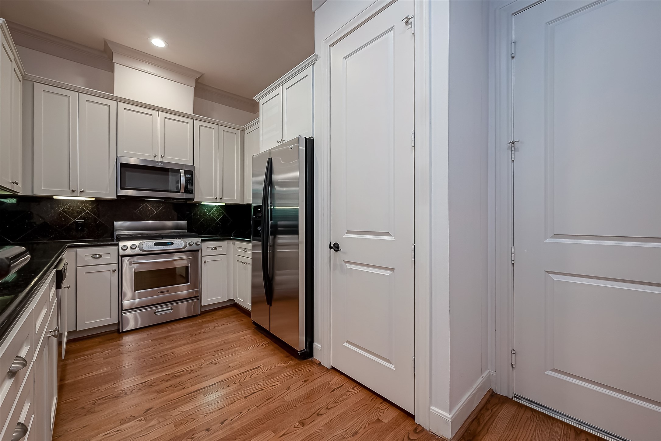 56 Riva Row The Woodlands, TX 77380 - Photo 16 of 36 a kitchen with a refrigerator stove and microwave