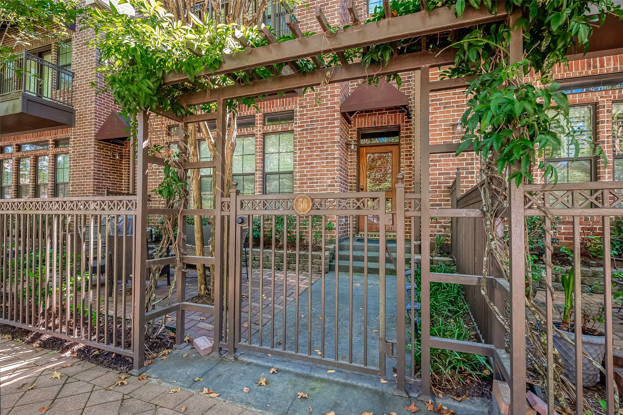 56 Riva Row The Woodlands, TX 77380 - Photo 2 of 36 a view of a house with a small yard and plants