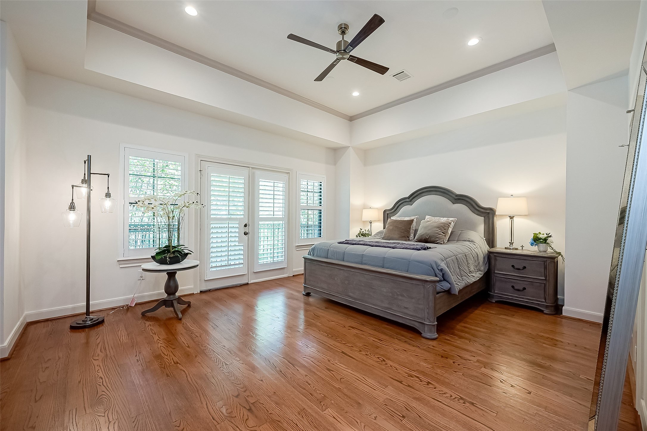 56 Riva Row The Woodlands, TX 77380 - Photo 21 of 36 a bedroom with a bed and wooden floor