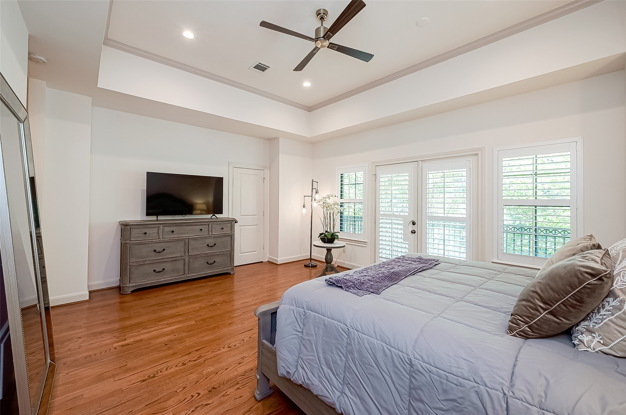 56 Riva Row The Woodlands, TX 77380 - Photo 22 of 36 a bedroom with a bed and a flat screen tv