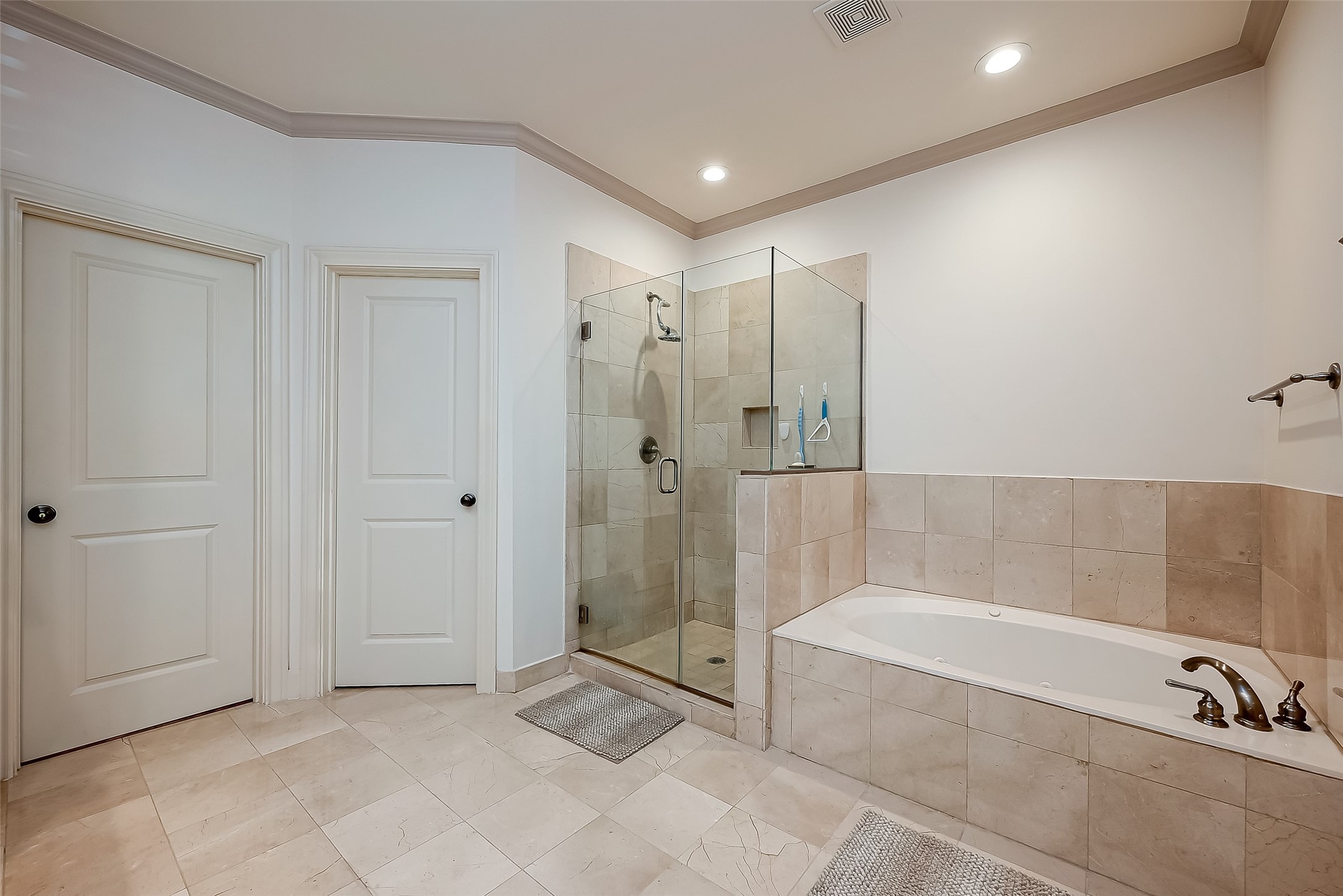 56 Riva Row The Woodlands, TX 77380 - Photo 25 of 36 a spacious bathroom with a tub shower and checkered floor