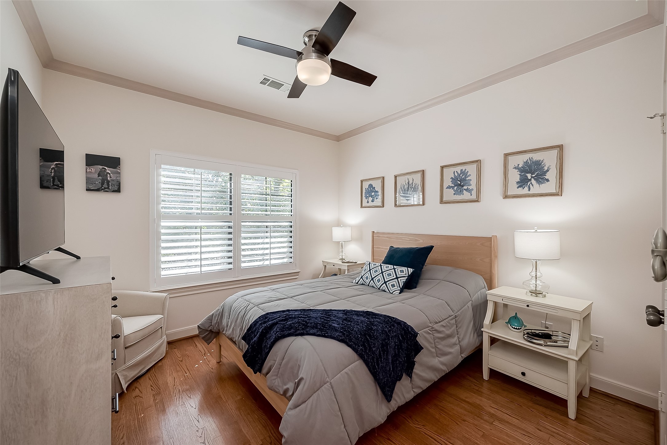 56 Riva Row The Woodlands, TX 77380 - Photo 28 of 36 a bedroom with a bed a couch and a window
