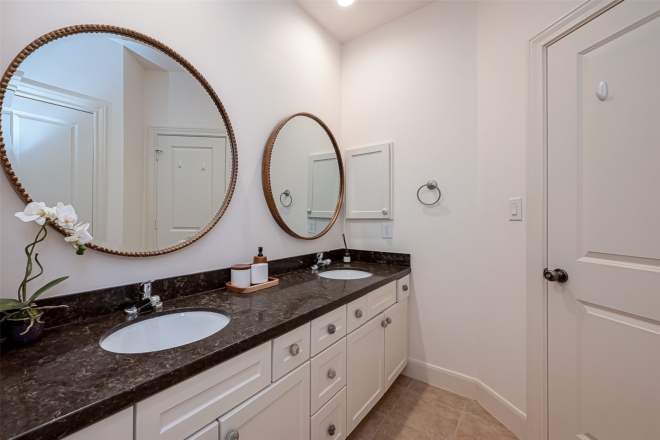56 Riva Row The Woodlands, TX 77380 - Photo 30 of 36 a bathroom with a granite countertop double vanity sinks and a mirror