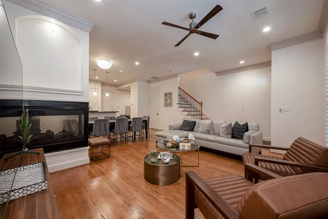 a living room with furniture kitchen view and a fireplace