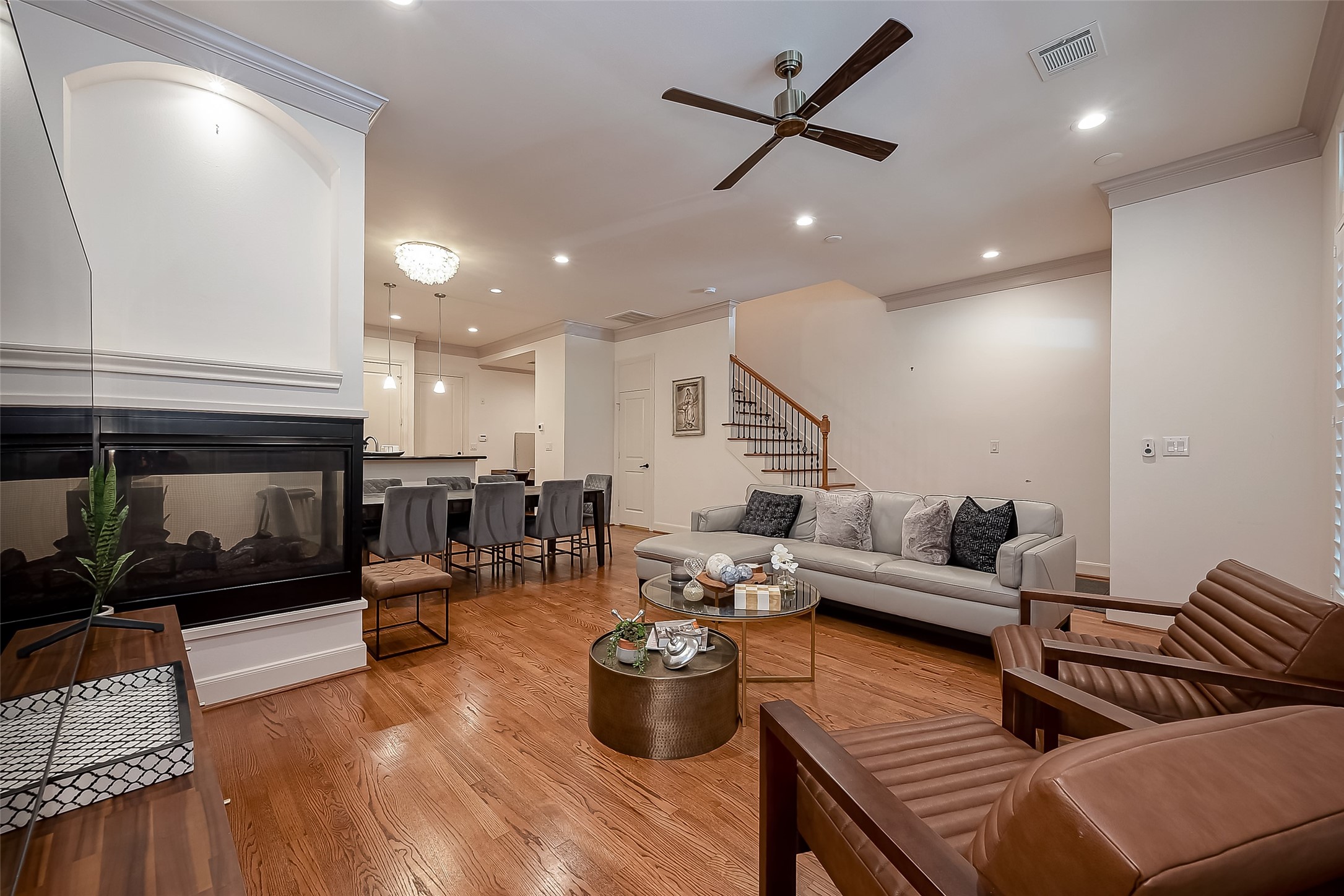 56 Riva Row The Woodlands, TX 77380 - Photo 7 of 36 a living room with furniture kitchen view and a fireplace