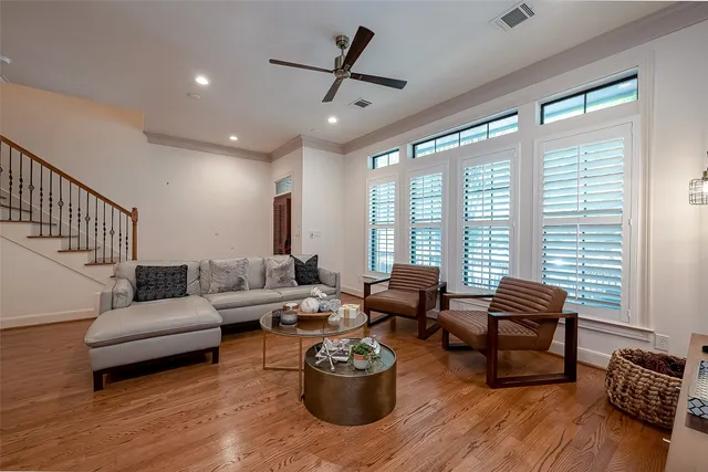 a living room with furniture and wooden floor
