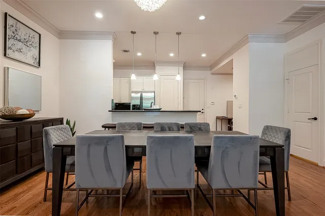 a view of a dining room with furniture and wooden floor