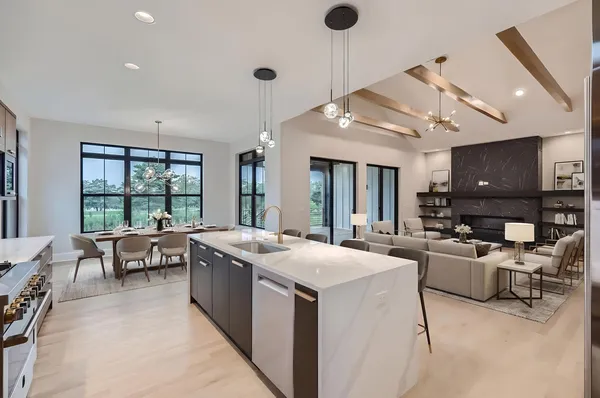 a living room with furniture a flat screen tv and a large window