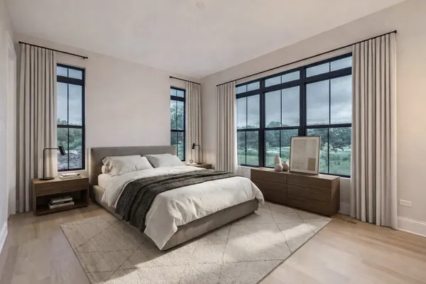 a bedroom with a bed and a large window
