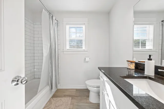 a view of hallway with stairs and wooden floor