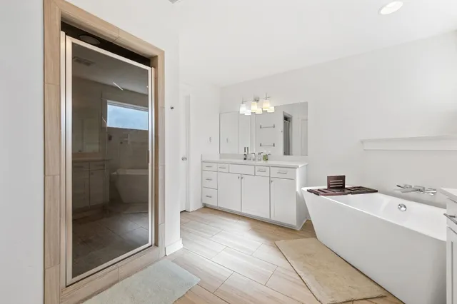 a large white kitchen with a sink and cabinets