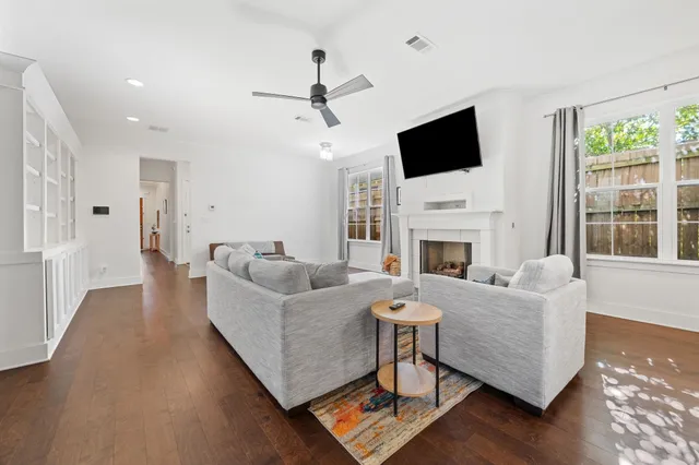 a living room with furniture fireplace and flat screen tv
