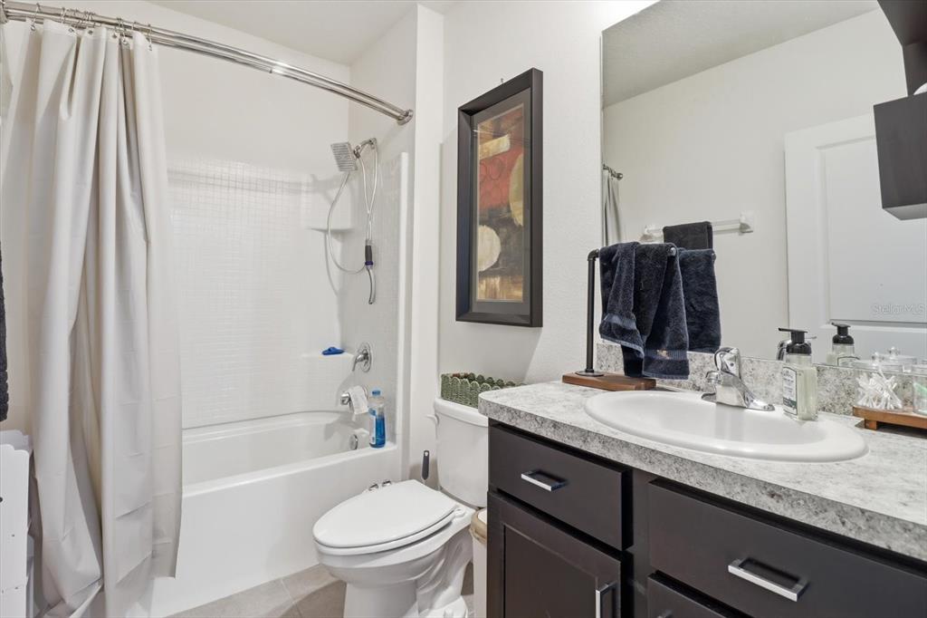660 Hickory Course Loop Ocala, FL 34472 - Photo 23 of 45 a bathroom with a granite countertop sink toilet and shower