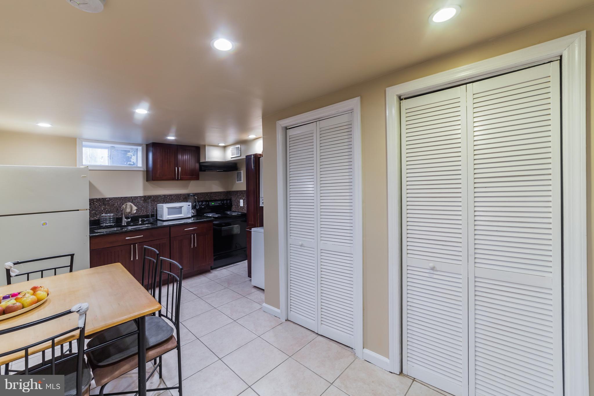 11704 Goodloe Road Silver Spring, MD 20906 - Photo 14 of 30 a kitchen with a refrigerator and a table