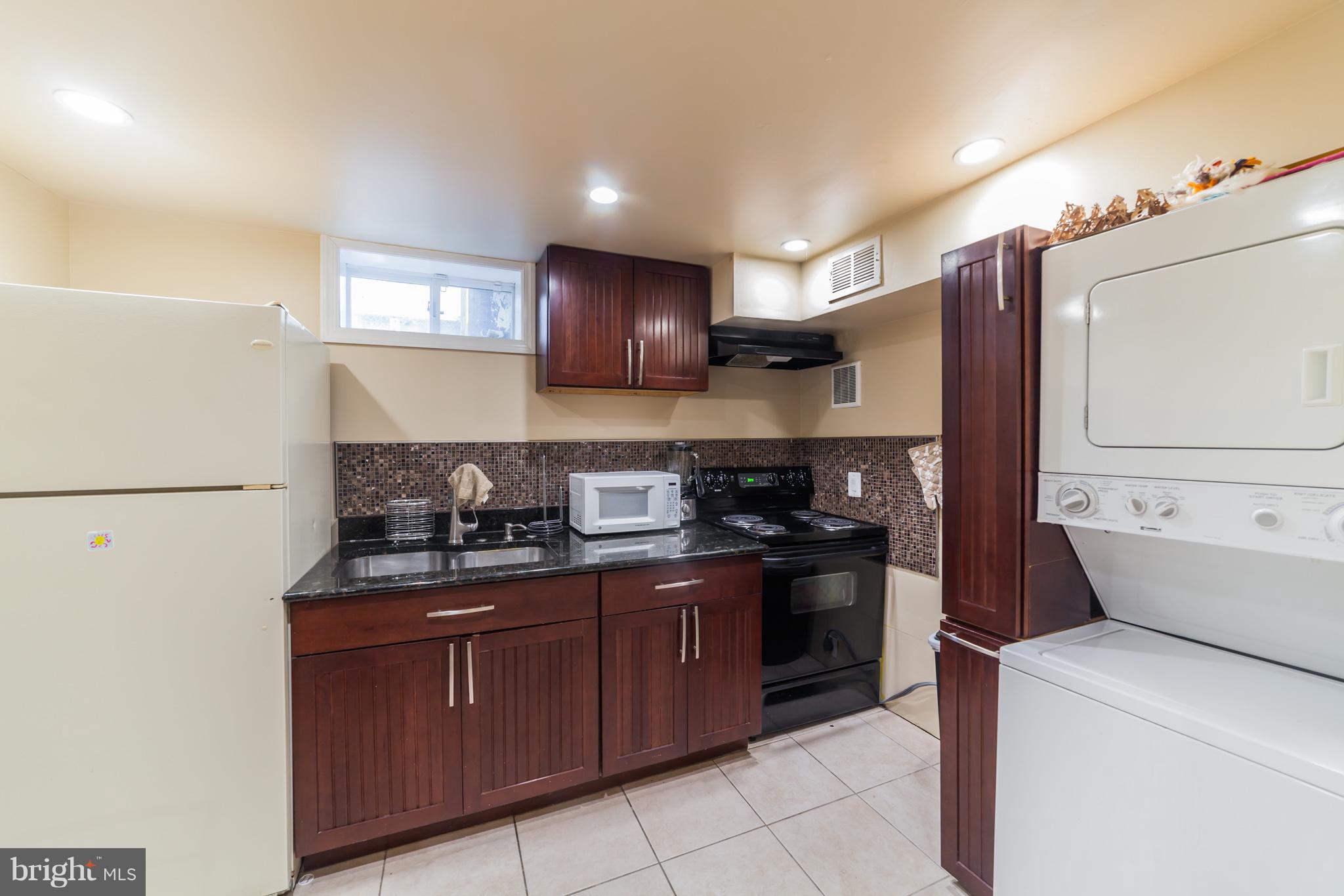 11704 Goodloe Road Silver Spring, MD 20906 - Photo 15 of 30 a kitchen with a sink a stove and refrigerator