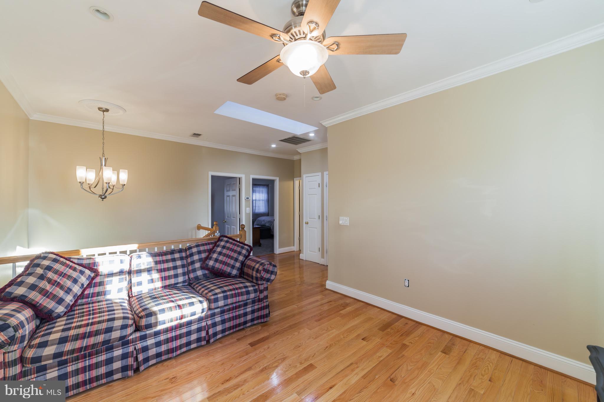 11704 Goodloe Road Silver Spring, MD 20906 - Photo 19 of 30 a spacious bedroom with a bed and a chandelier