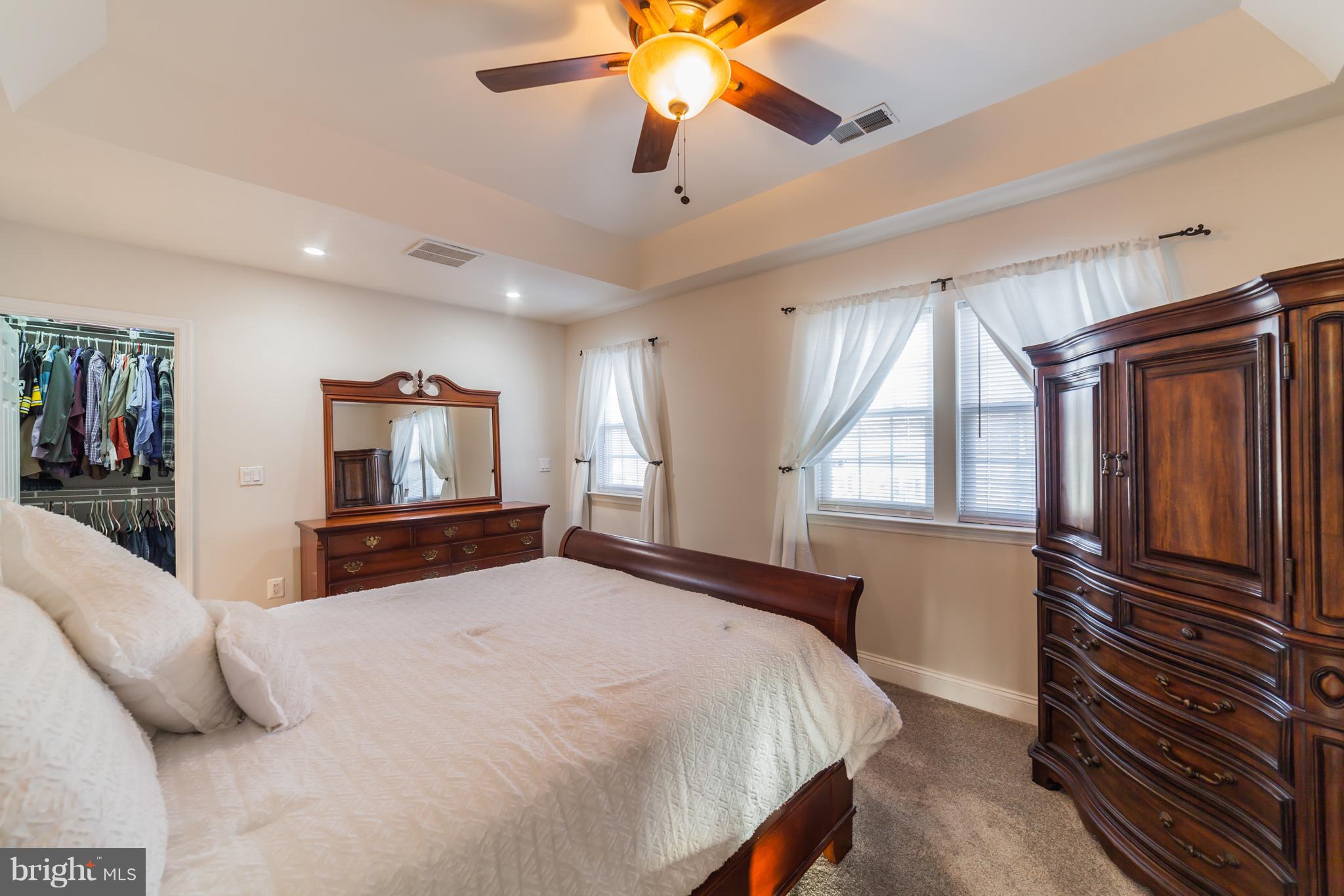 11704 Goodloe Road Silver Spring, MD 20906 - Photo 21 of 30 a bedroom with a bed and a flat screen tv