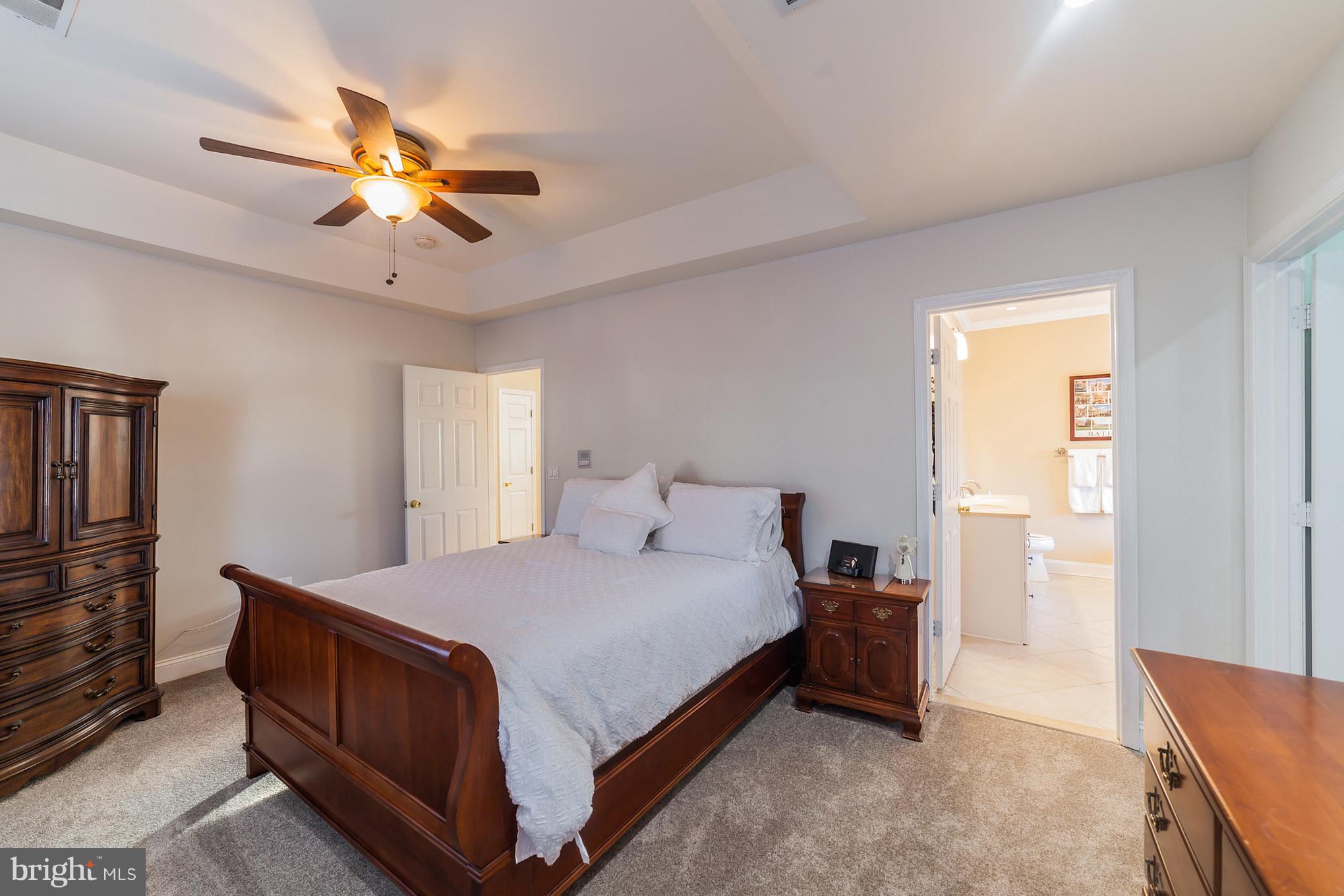 11704 Goodloe Road Silver Spring, MD 20906 - Photo 22 of 30 a bedroom with a bed and a chandelier