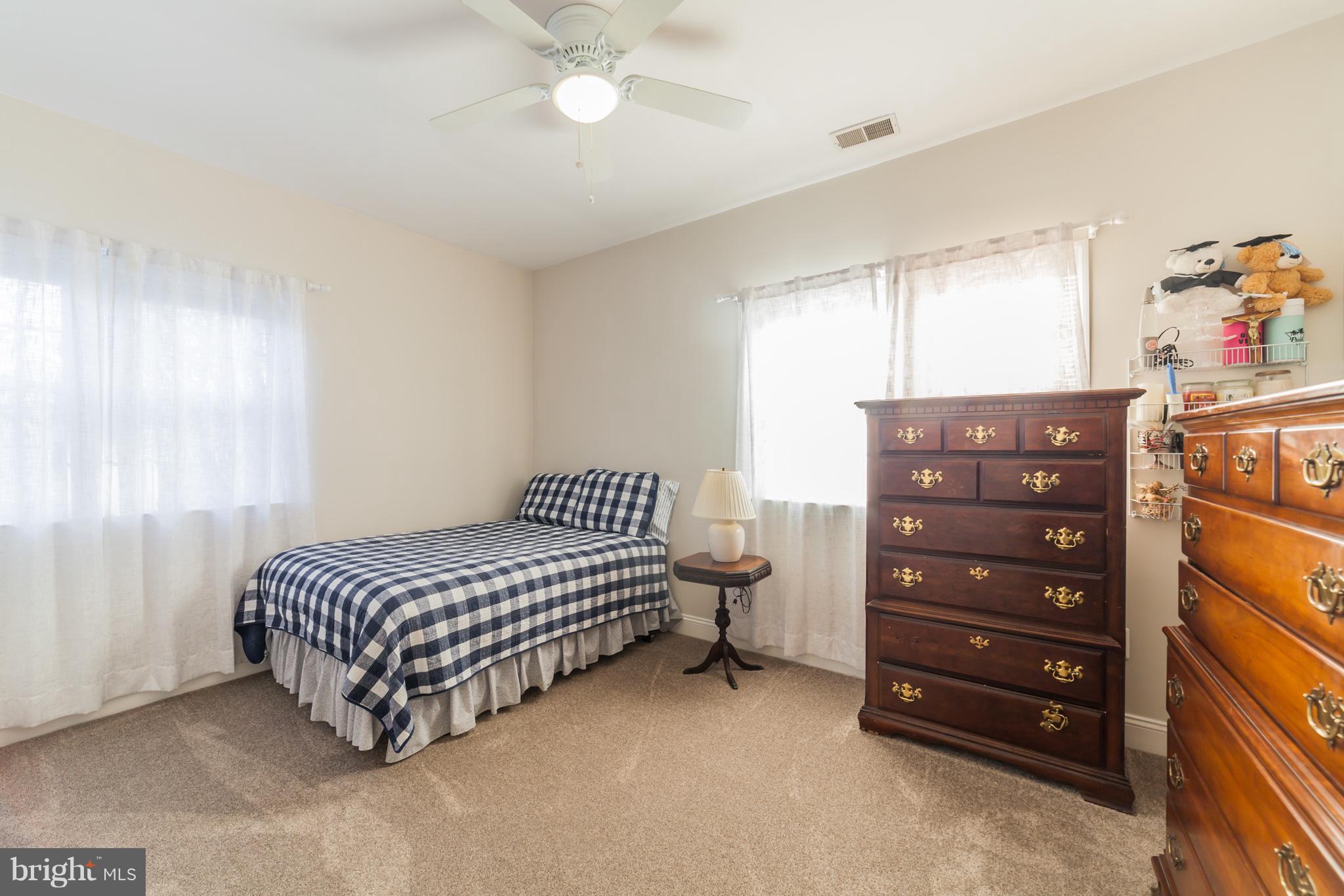 11704 Goodloe Road Silver Spring, MD 20906 - Photo 26 of 30 a bedroom with a bed and a dresser